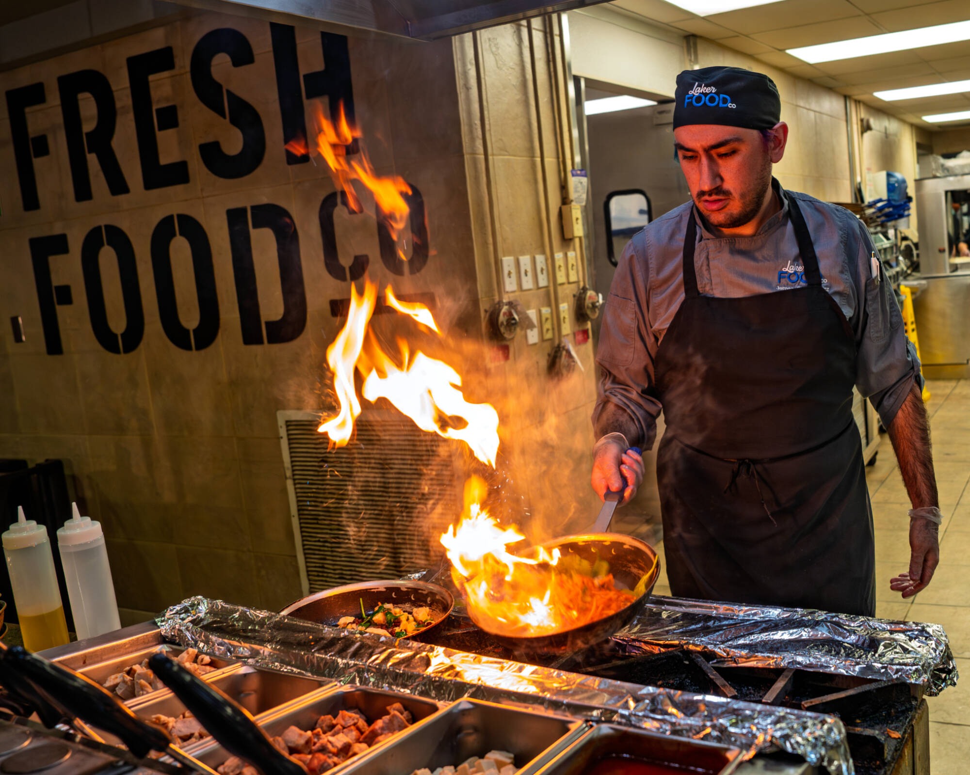 Chef James  Cembrowicz cooks at the “Fire and Ice” sauté station inside the Fresh Food Company on January 13.